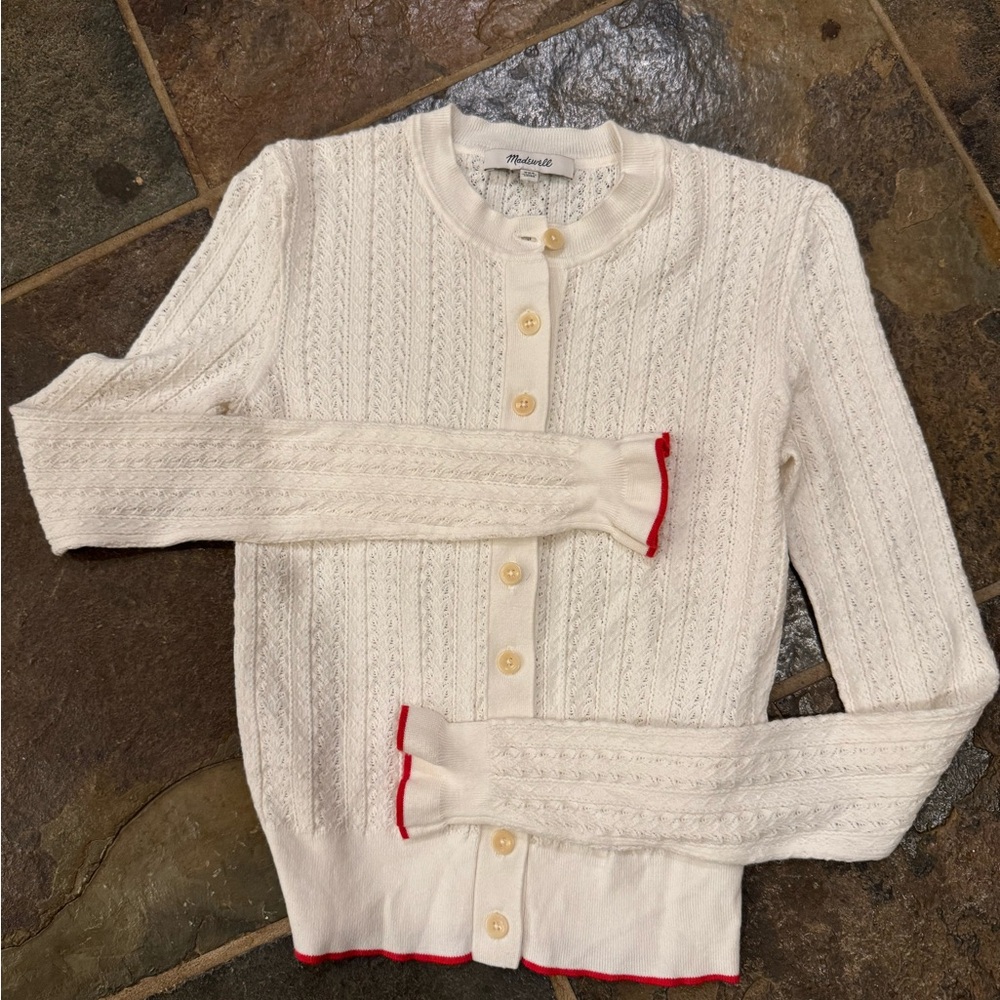 White Madewell cardigan with red trim at hem and cuffs.